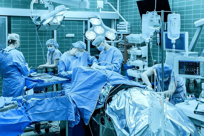 surgeons performing brain surgery stock photo